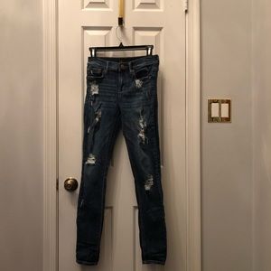 EXPRESS DISTRESSED MID RISE LEGGING SKINNY JEANS